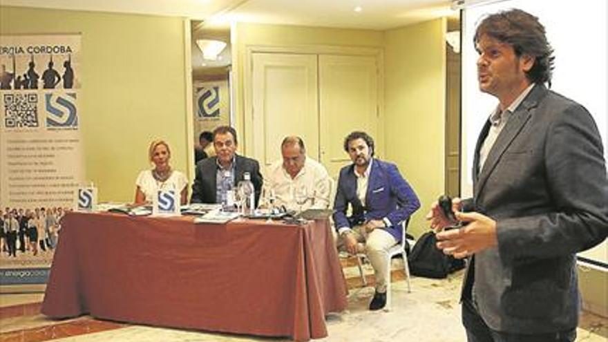Presentación de Sinergia Córdoba en el hotel Ayre, con un ponente de pie ante la mesa